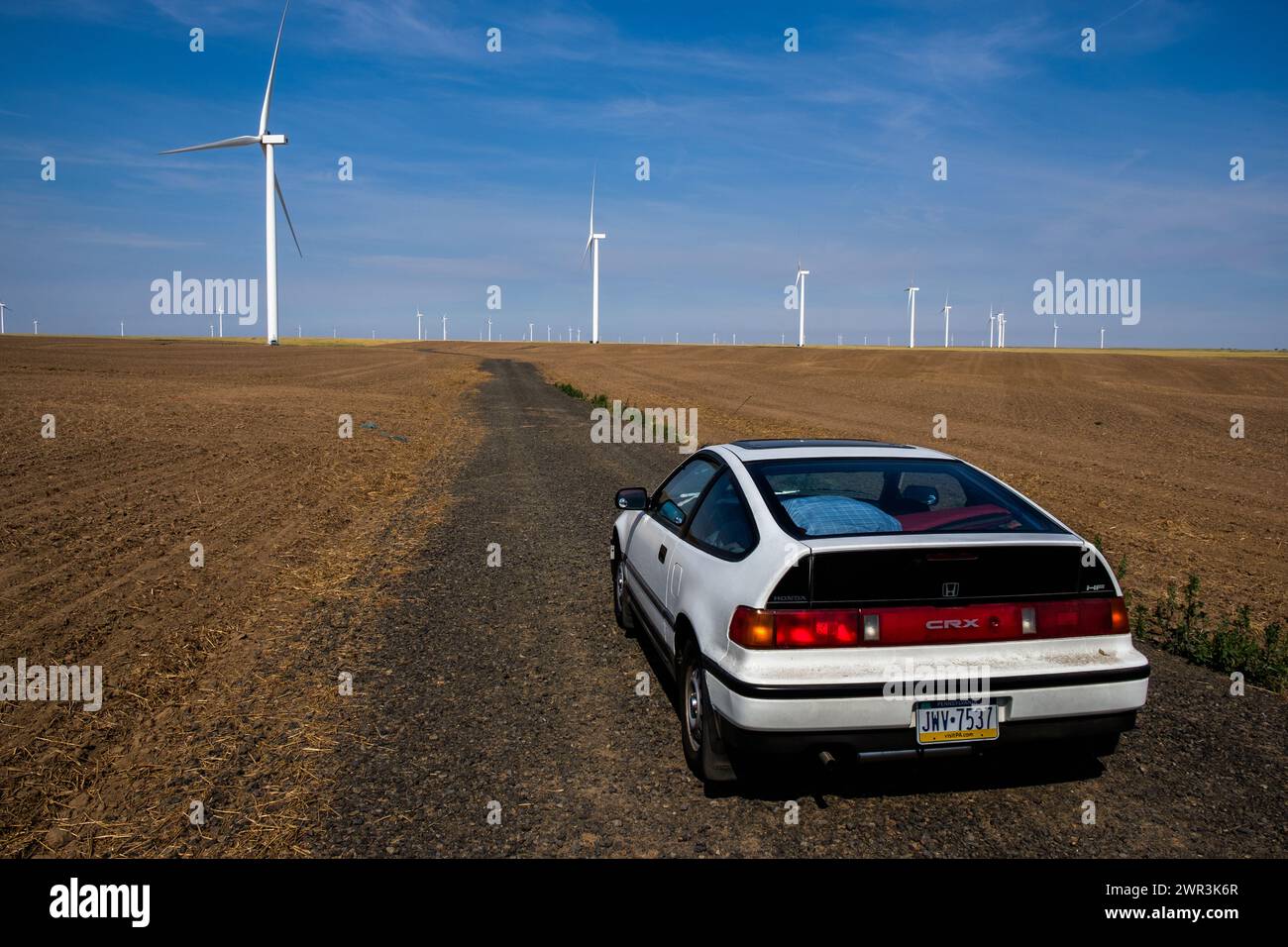 Honda CRX parked by wind turbines in eastern Washington State USA. Stock Photo