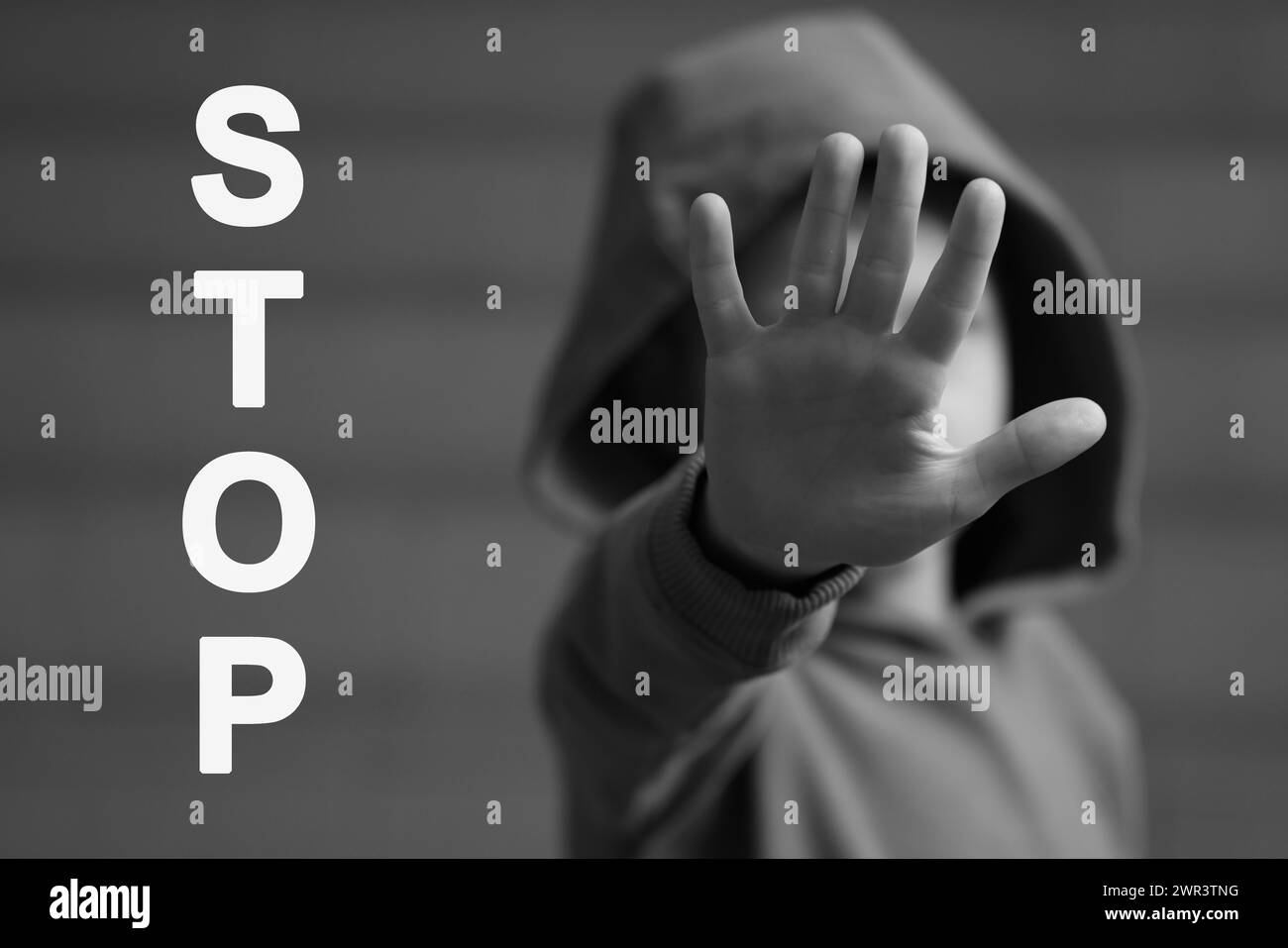 No child abuse. Boy making stop gesture, selective focus. Black and white effect Stock Photo