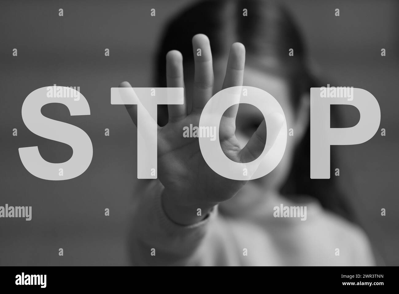 No child abuse. Girl making stop gesture, selective focus. Black and white effect Stock Photo