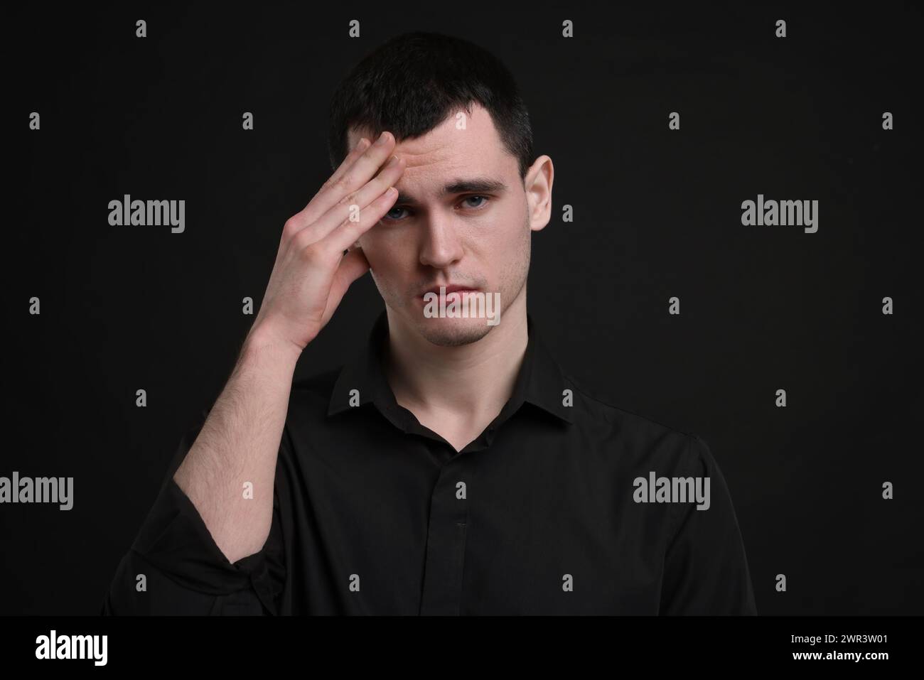 Portrait of sad man on black background Stock Photo - Alamy