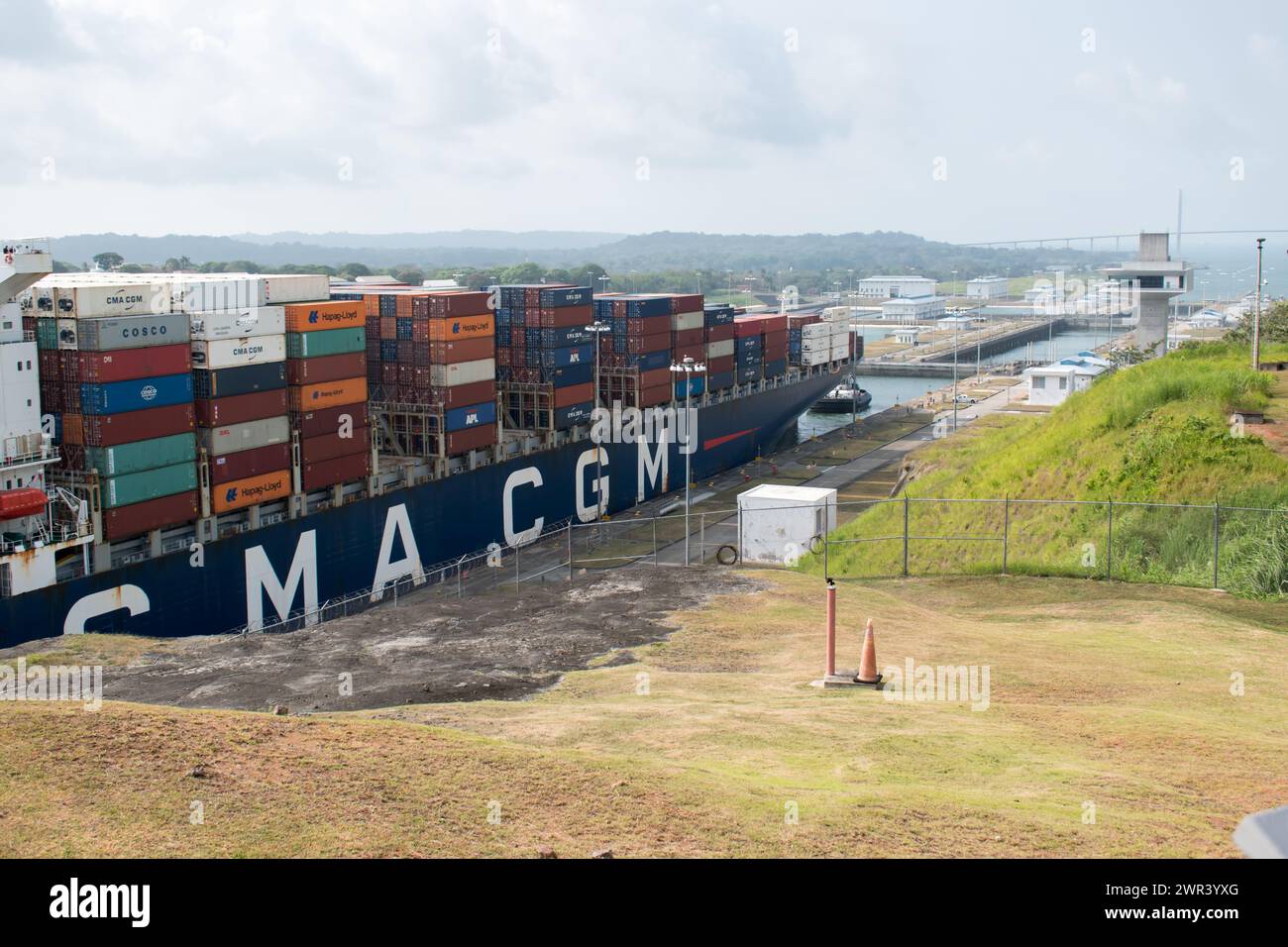 A container ship transiting through the Panama Canal from the Pacific side to the Caribbean side, seen from the Agua Clara Visitor Center. Stock Photo