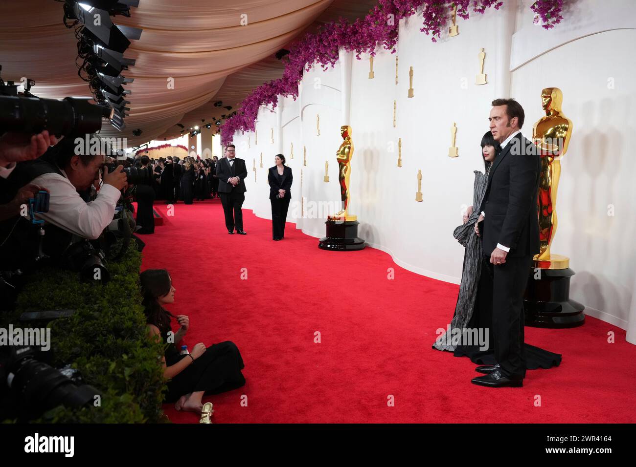 From left, Riko Shibata and Nicolas Cage arrive at the Oscars on Sunday