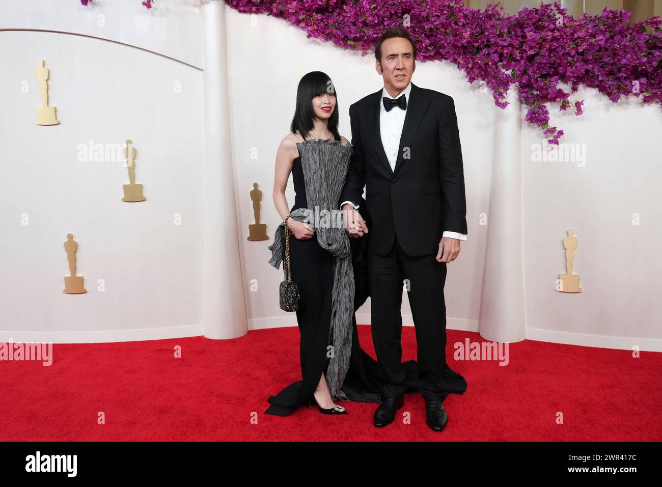 From left, Riko Shibata and Nicolas Cage arrive at the Oscars on Sunday(02)