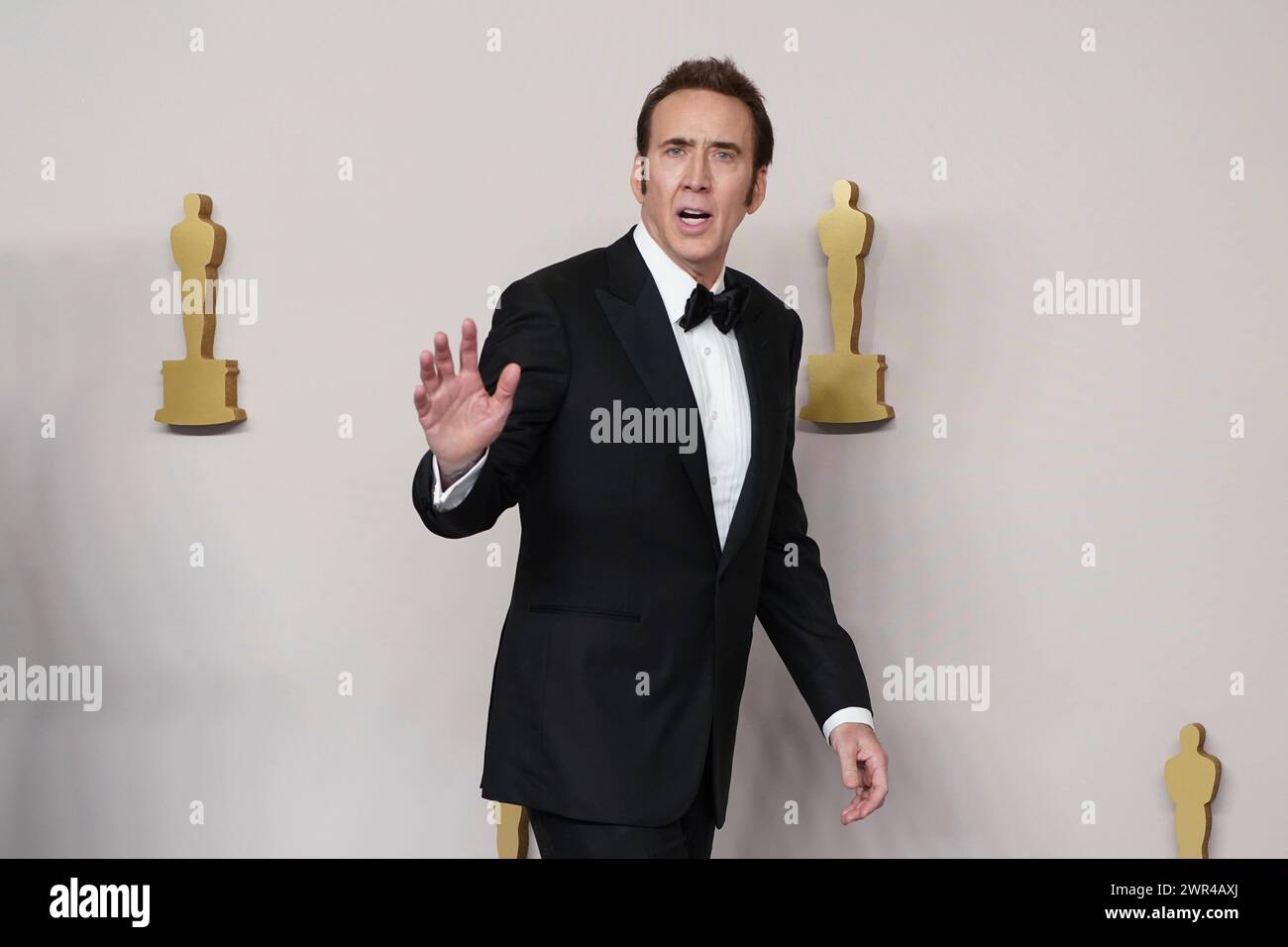 Nicolas Cage poses in the press room at the Oscars on Sunday, March 10