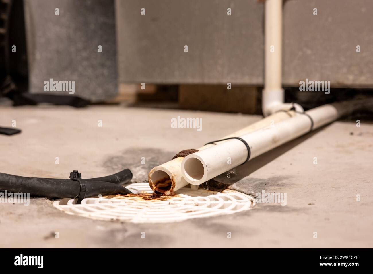Selective focus on a residential house basement floor drain with
