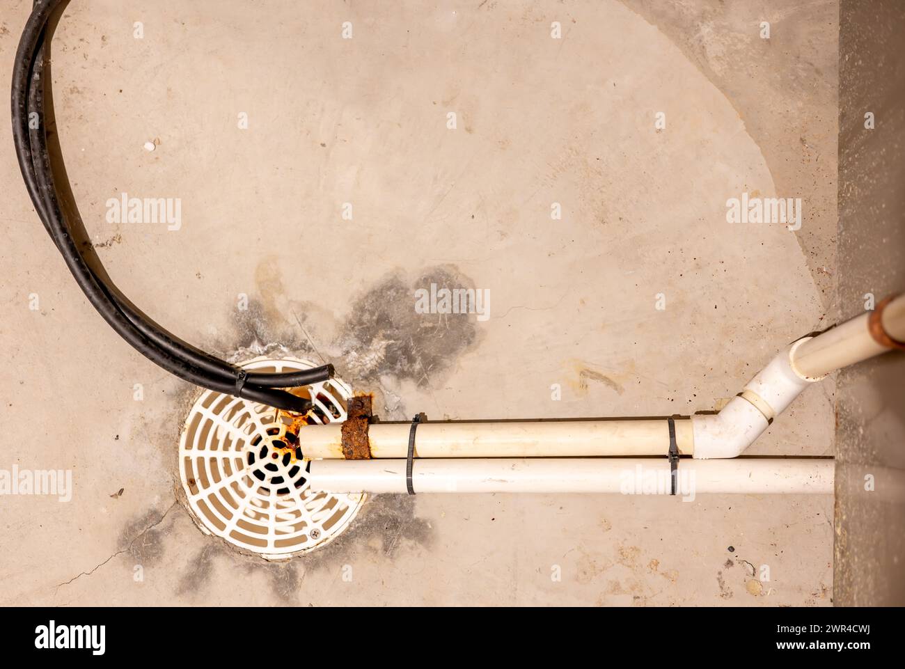 Selective focus on a residential house basement floor drain with