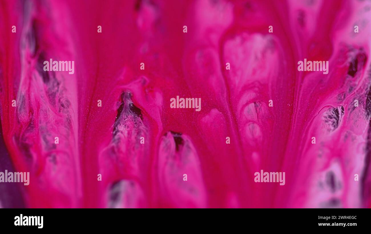 Shimmering paint drip ink flow pink white mix Stock Photo - Alamy