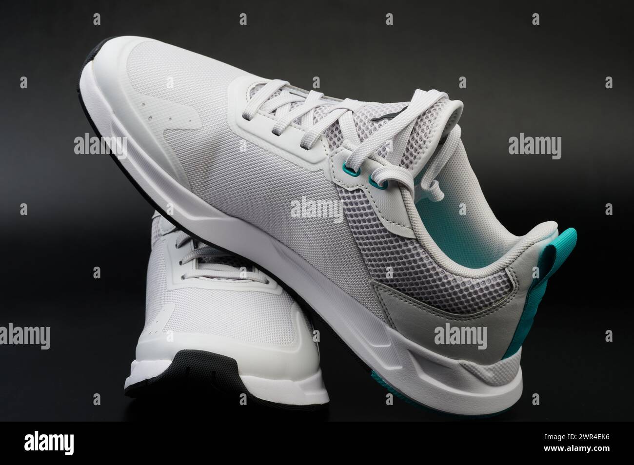 Pair of white shoes with laces on black studio background Stock Photo ...