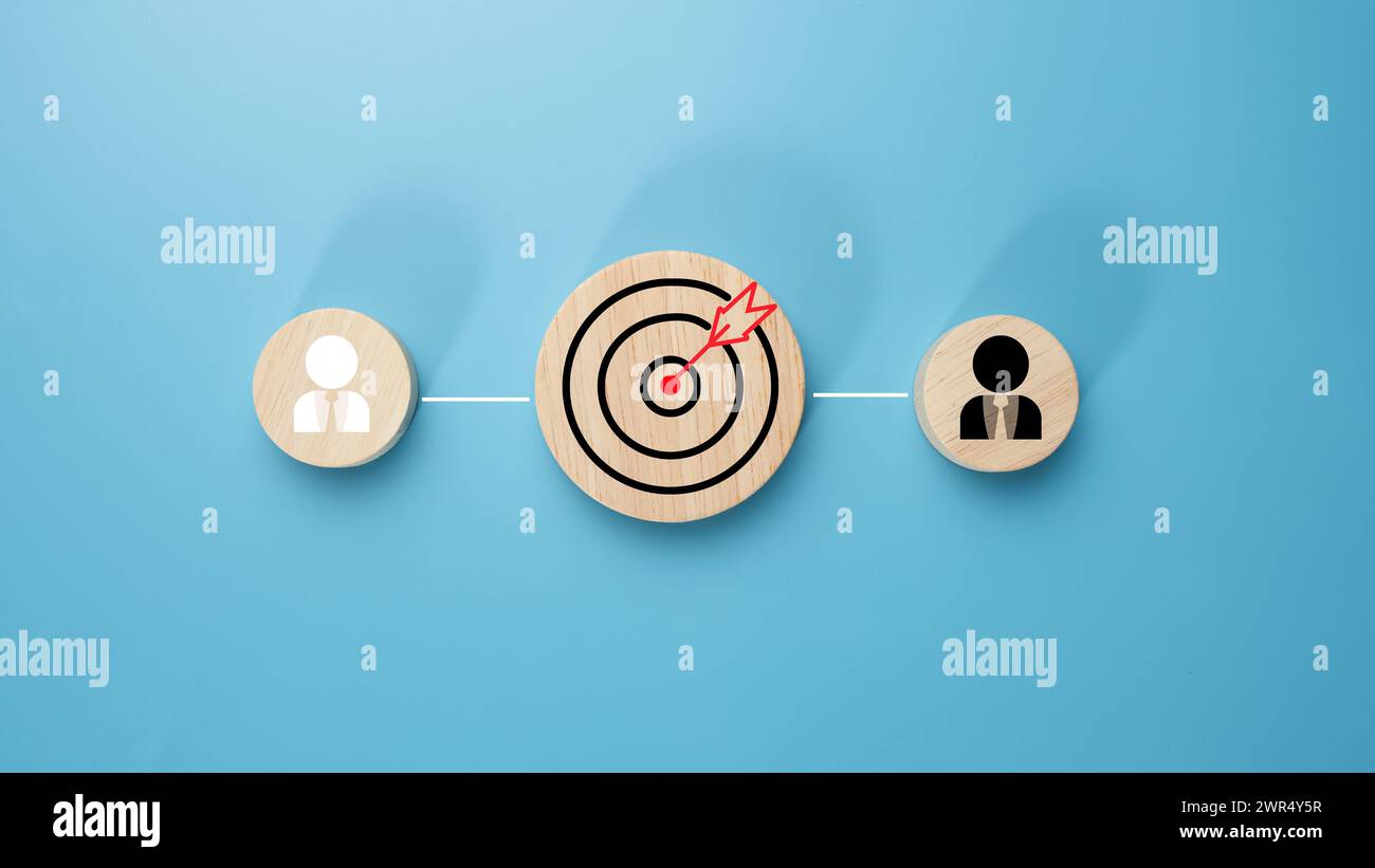 Circular wood with printed target icons and business symbols on light blue background, business goals and objectives concept, business competition, Cu Stock Photo
