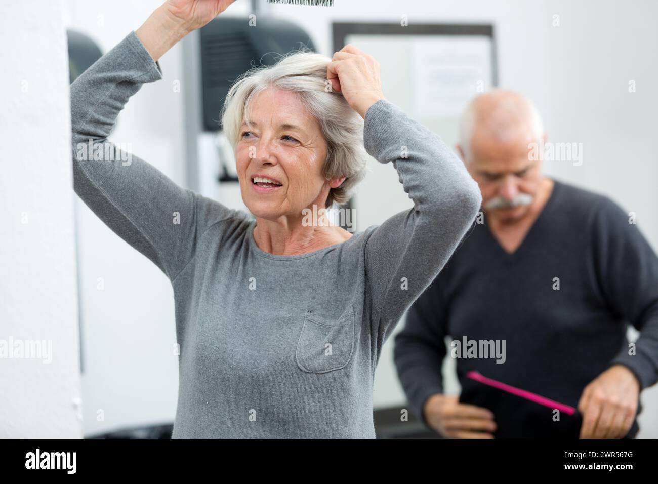 Elderly woman combing hair in hi-res stock photography and images - Alamy