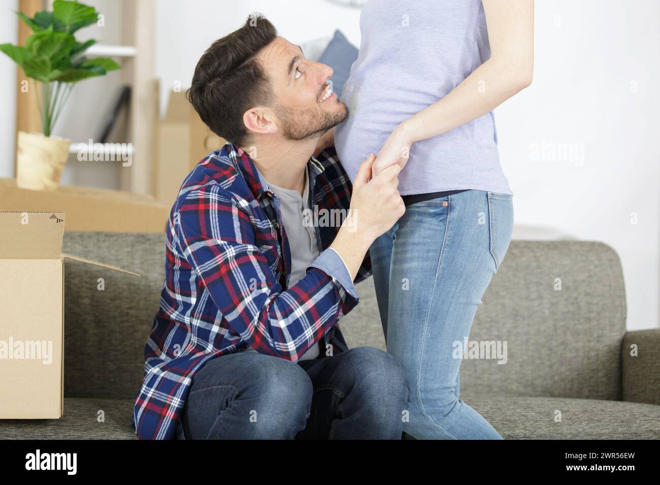 happy man hugging pregnant woman at home Stock Photo - Alamy