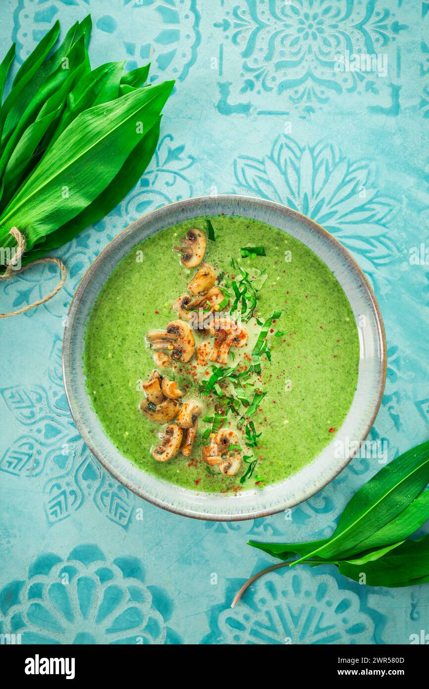 Creamy homemade bear leek soup or ramson soup with fried champignons Stock Photo