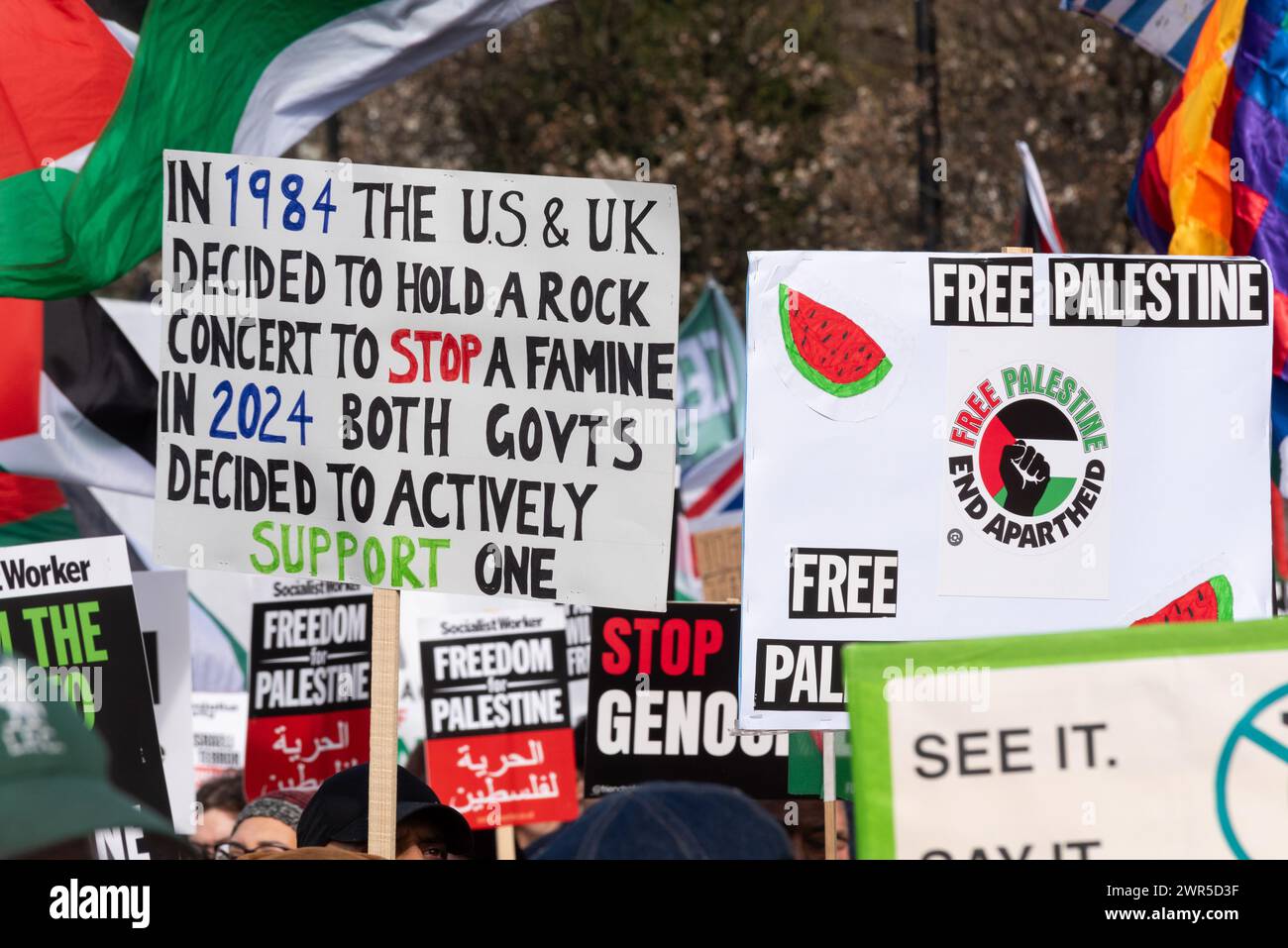 Pro Palestine protest march in London, UK, protesting against the conflict in Gaza and against Israel occupation. Placard with Live Aid reference Stock Photo