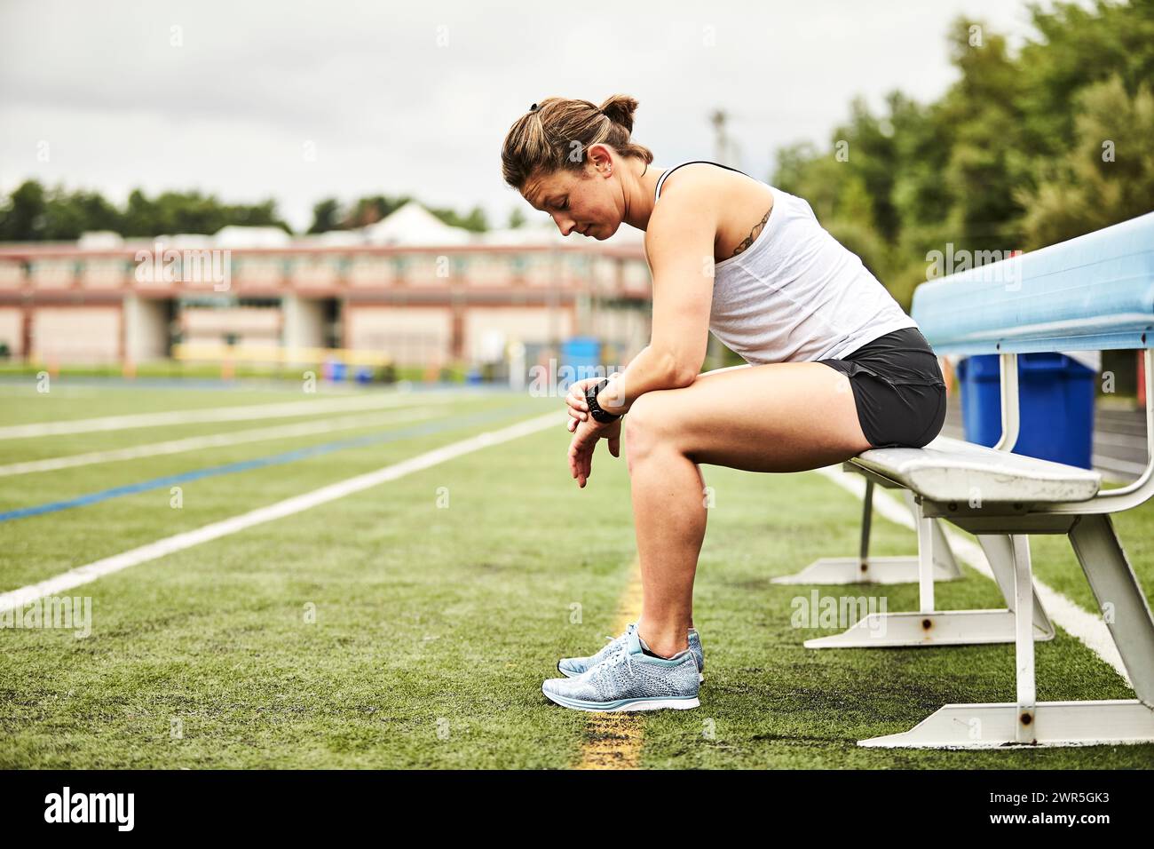Female athlete checking fitness tracker watch, Lincoln, Massachusetts, USA Stock Photo