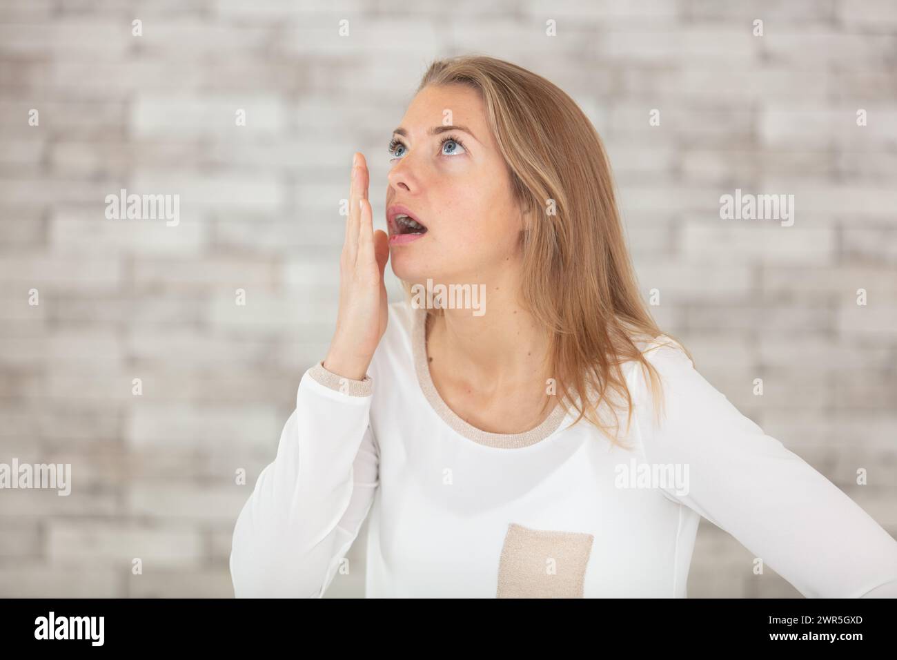 young bored woman yawning at home Stock Photo