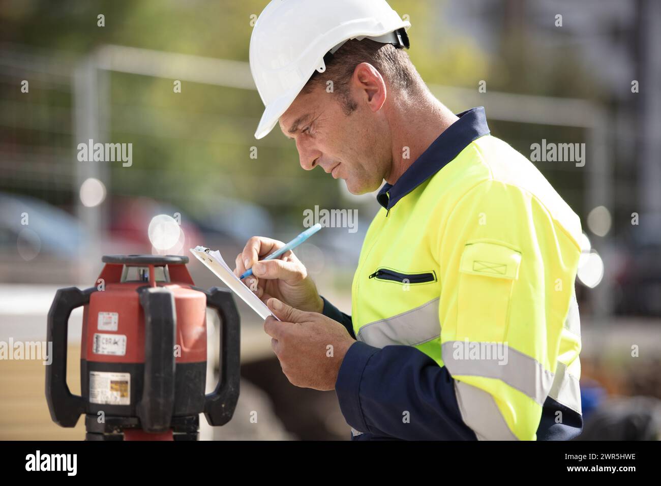 surveyor making notes on site Stock Photo