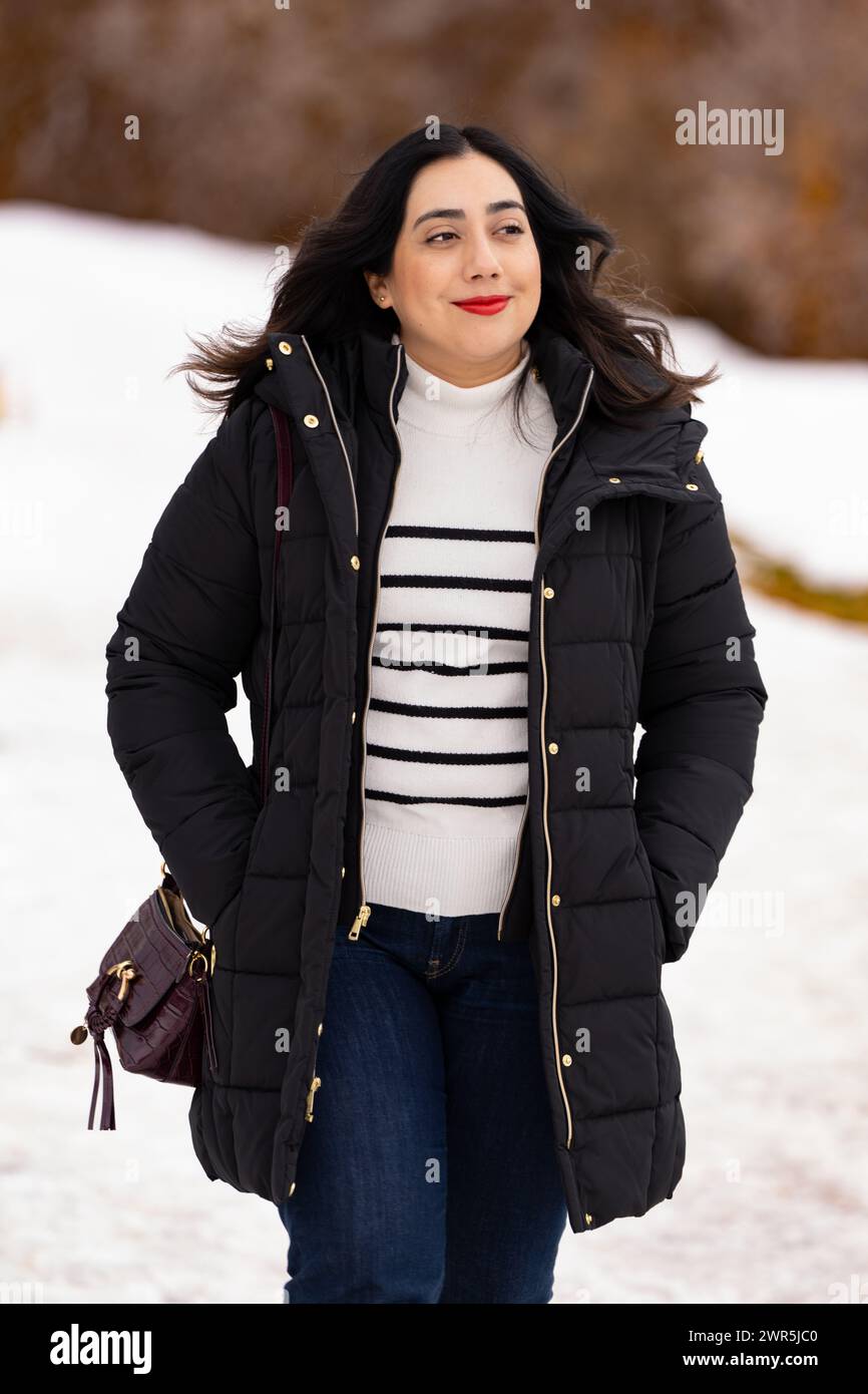 Latin American women walking in the snow Stock Photo