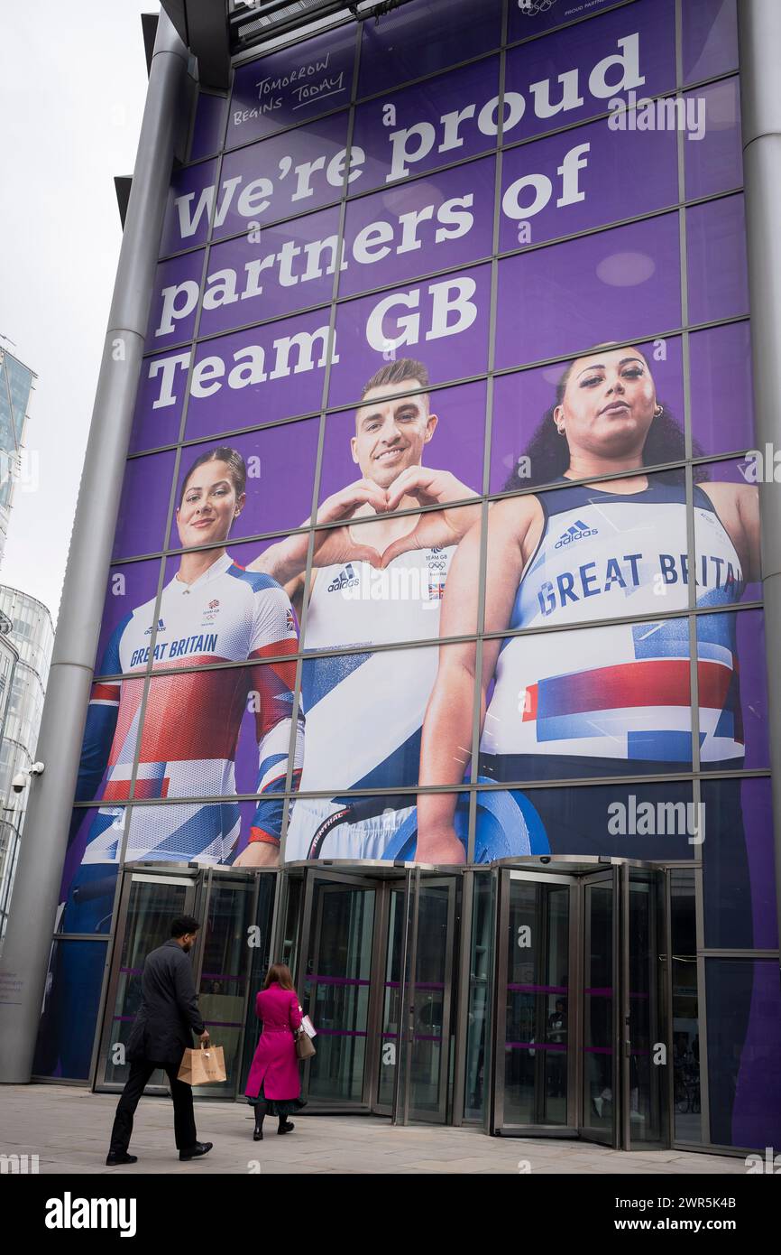 With months before the 2024 Paris Olympics, a huge image of Team GB athletes, BMX rider Beth Shriever, gymnast Max Whitlock and weightlifter Emily Campbell is seen at the entrance to Natwest Bank on Bishopsgate in the City of London, the capital's financial district, on 7th March 2024, in London, England. Natwest and Coutts Bank are currently Team GB's official corporate partners. Stock Photo