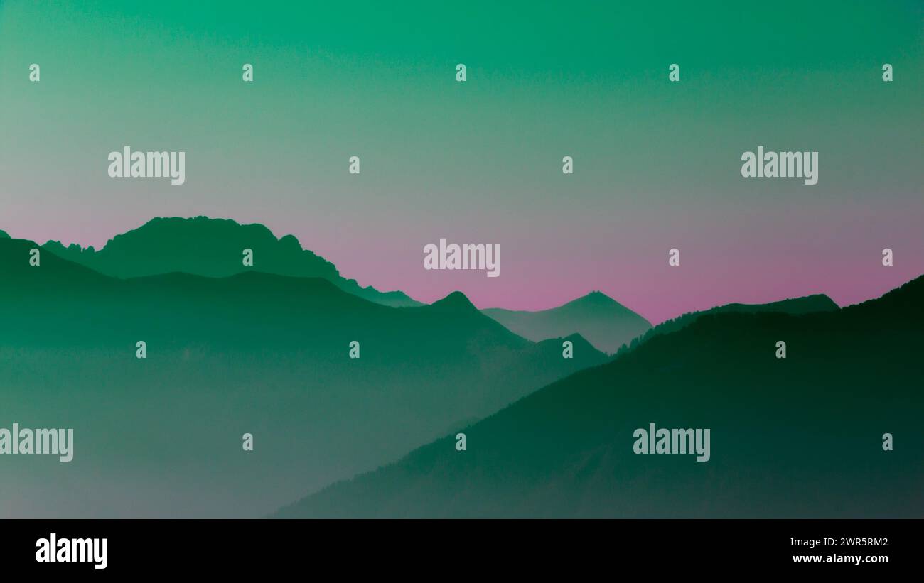 Spectacular mountain ranges silhouettes in shades of green and purple. Stock Photo