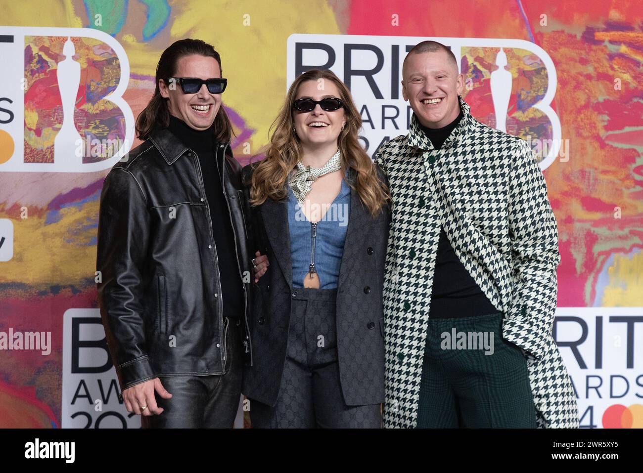 London, UK. March 2nd, 2024.   (EDITORIAL USE ONLY. NO PUBLICATIONS DEVOTED EXCLUSIVELY TO THE ARTIST) (L to R) Tom McFarland, Lydia Kitto and Joshua Lloyd-Watson of Jungle attend the BRIT Awards 2024 at The O2 Arena on March 02, 2024 in London, England. Credit: S.A.M./Alamy Live News Stock Photo