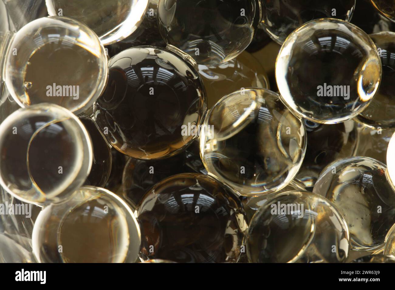 Scented gel beads (hydrogel) in close-up, light reflections. Background. Stock Photo