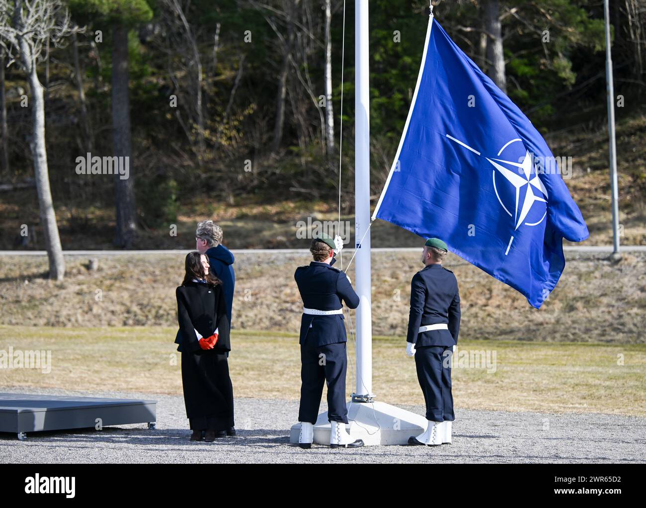 The Swedish Minister of justice  Gunnar Strömmer  and the Minister of Climate Romina Pourmokhtari attending the ceremony when the NATO flag  is raised  at the Musko navy base  outside Stockholm Monday 11 March.Photo: Fredrik Sandberg / TT / Code 10080 Stock Photo