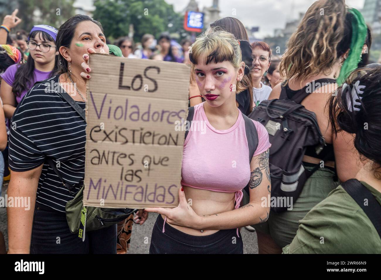 A young woman displays a sign that reads  'rapists existed before miniskirts' during the International Women's Day. Thousands of women gathered for International Women's Day at the National Congress in Buenos Aires. The columns of activists began to arrive at 4:00 p.m. Some of the slogans chosen were 'A la violencia machista, feminismo', 'ni un paso atrás', 'fuimos marea, seremos tsunami', as well as posters criticizing the government of Javier Milei.There were also graphic and performative interventions, with music and dance. (Photo by Rosana Alvarez Mullner / SOPA Images/Sipa USA) Stock Photo