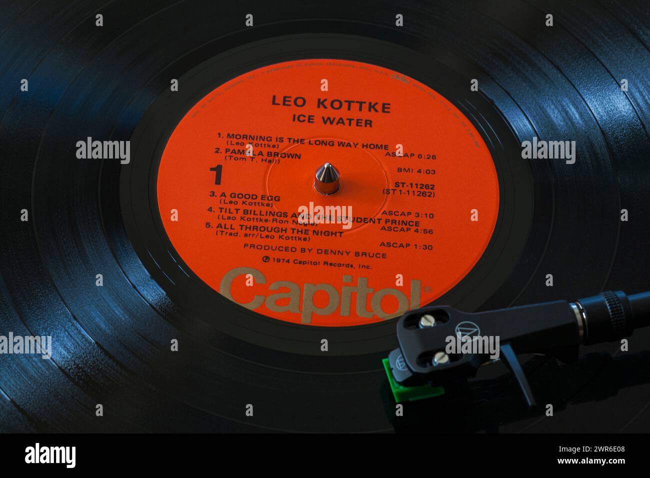 Leo Kottke Ice Water vinyl record album LP with tonearm, cartridge, headshell and stylus on turntable record player - 1974 Stock Photo