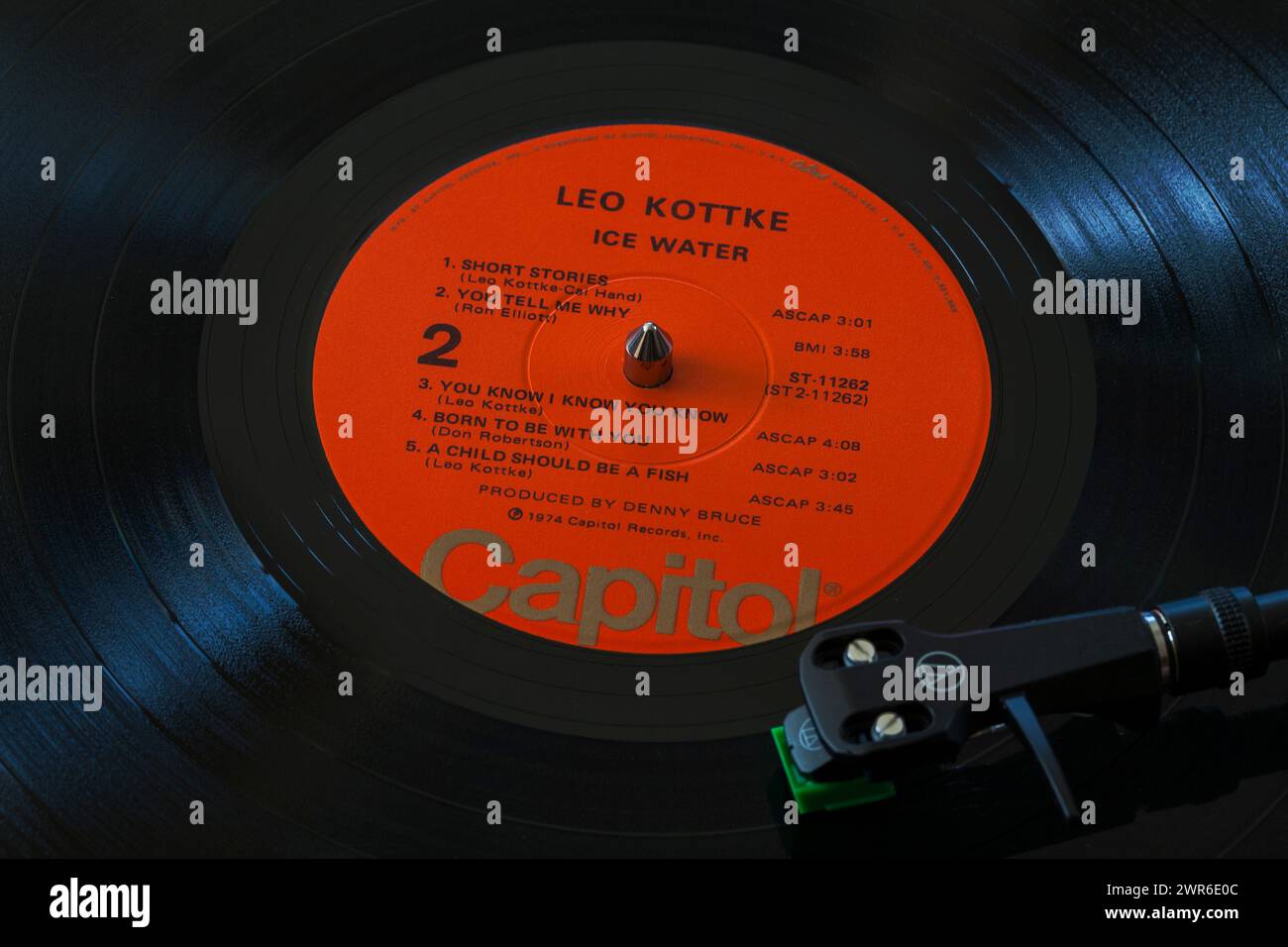 Leo Kottke Ice Water vinyl record album LP with tonearm, cartridge, headshell and stylus on turntable record player - 1974 Stock Photo