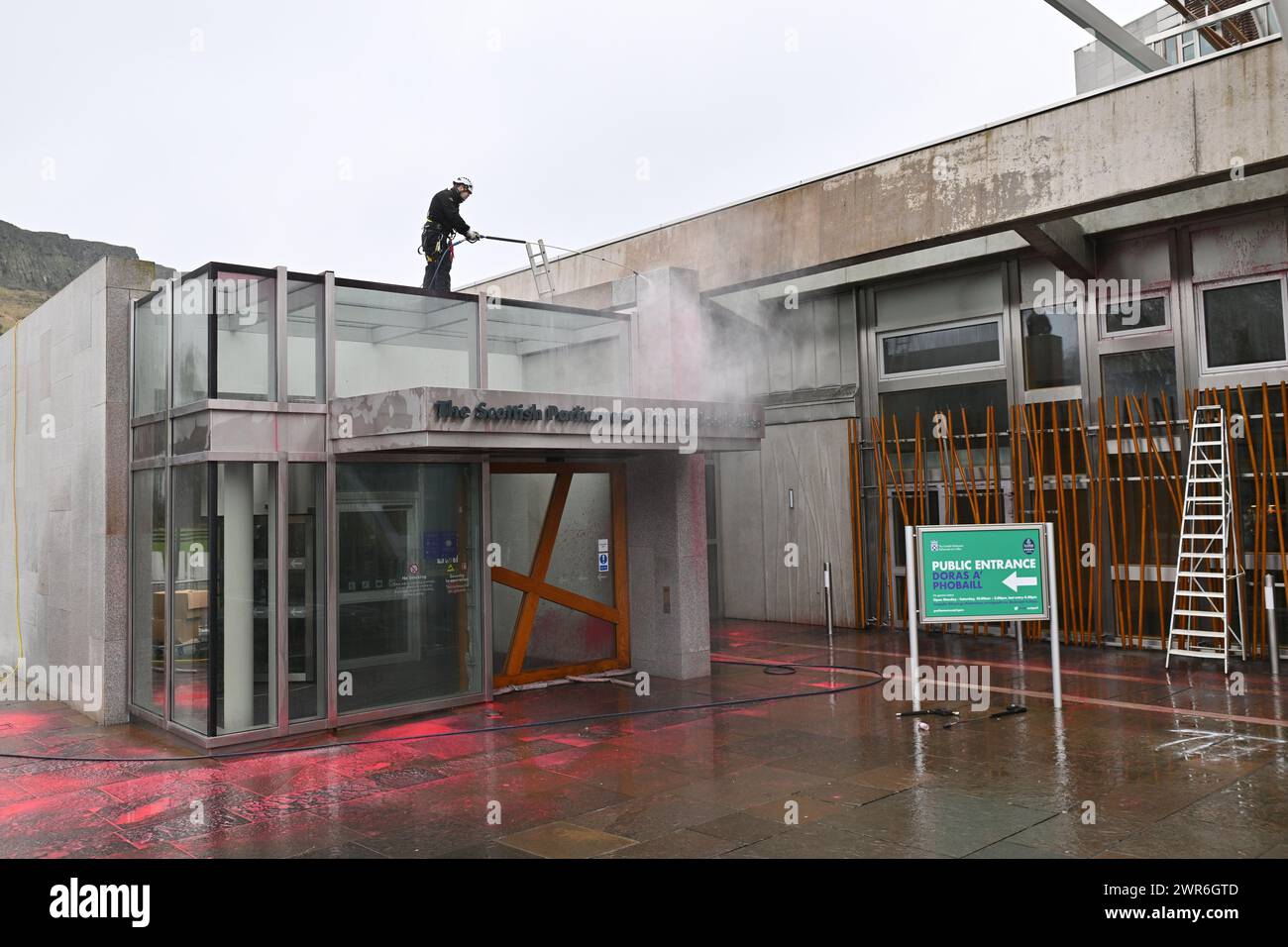 Edinburgh Scotland, UK 11 March 2024. The clean up following the Scottish Parliament Public Entrance  being covered with red paint by protesters. credit sst/alamy live news Stock Photo