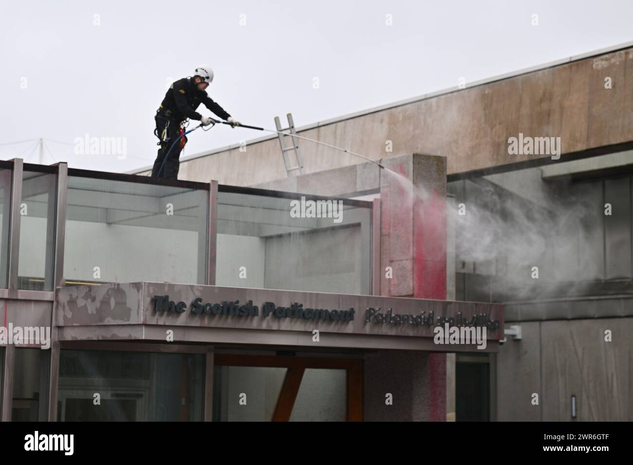 Edinburgh Scotland, UK 11 March 2024. The clean up following the Scottish Parliament Public Entrance  being covered with red paint by protesters. credit sst/alamy live news Stock Photo