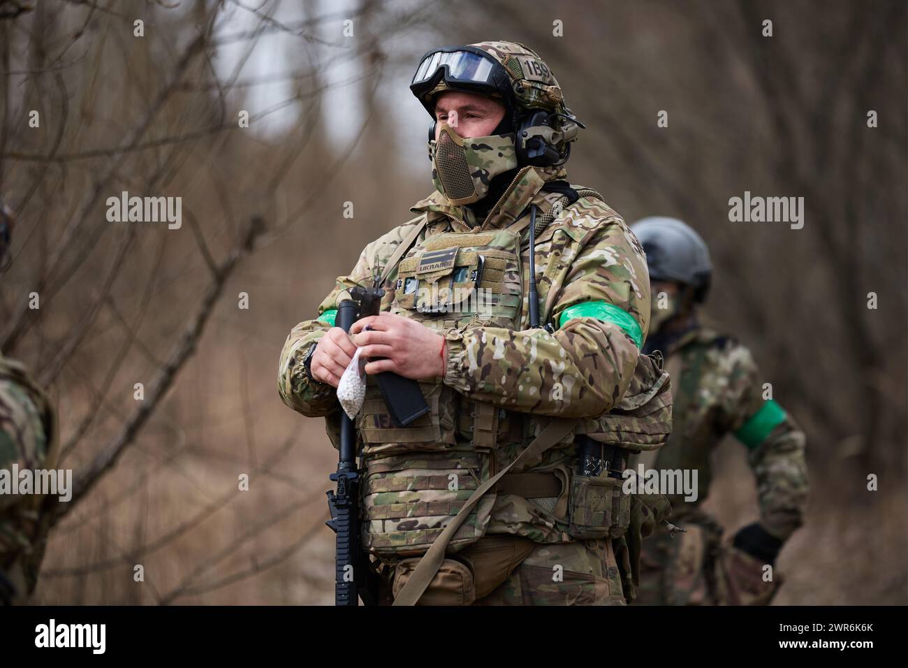 Ukrainian soldier in combat ammunition training with airsoft rifle on a ...