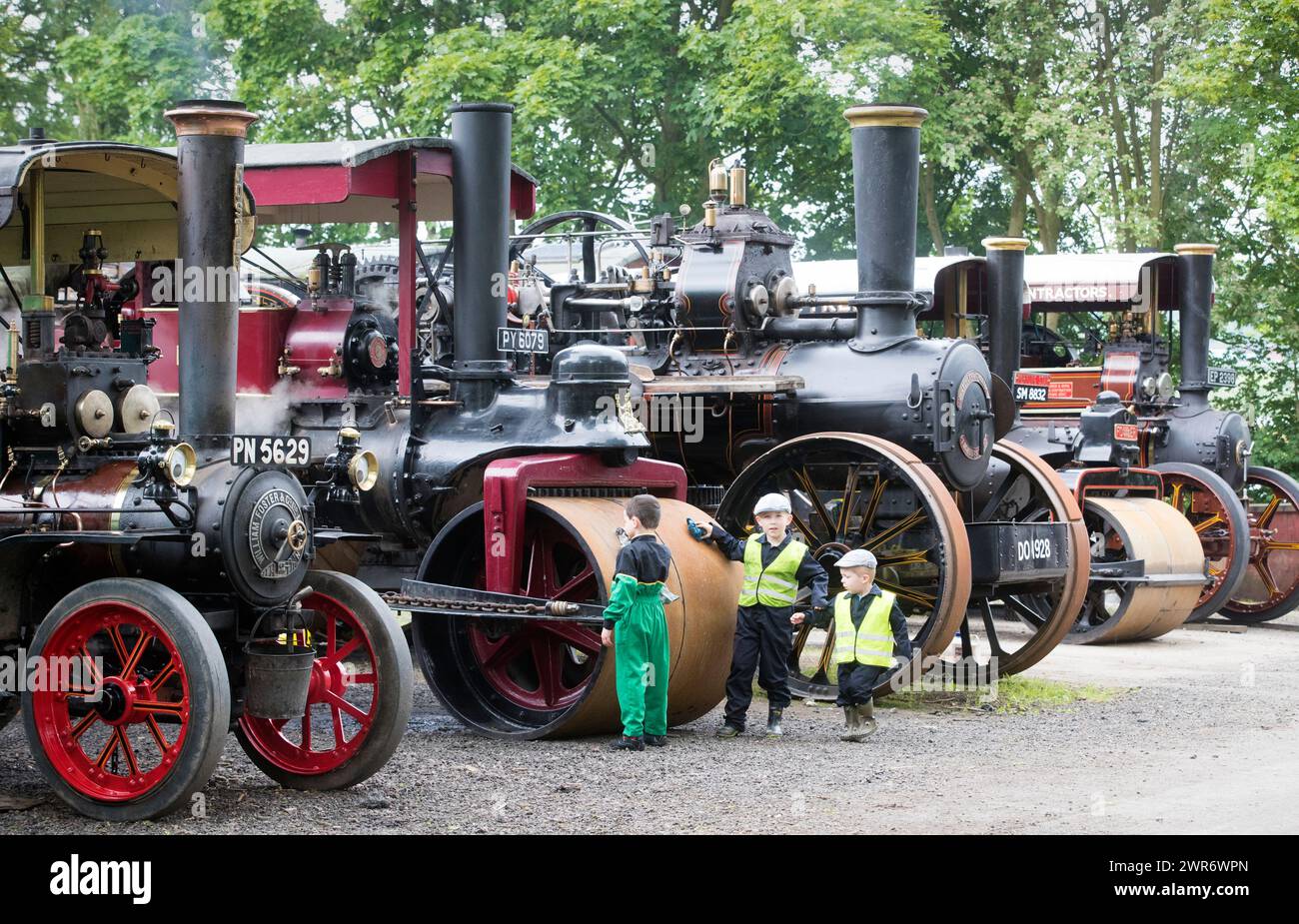 02/07/18  L/R: Lucas Foster (5) and Jude Hutton (6) and Flynn Hutton use oily rags to clean their parents' traction engines.  Traction engines,  some Stock Photo