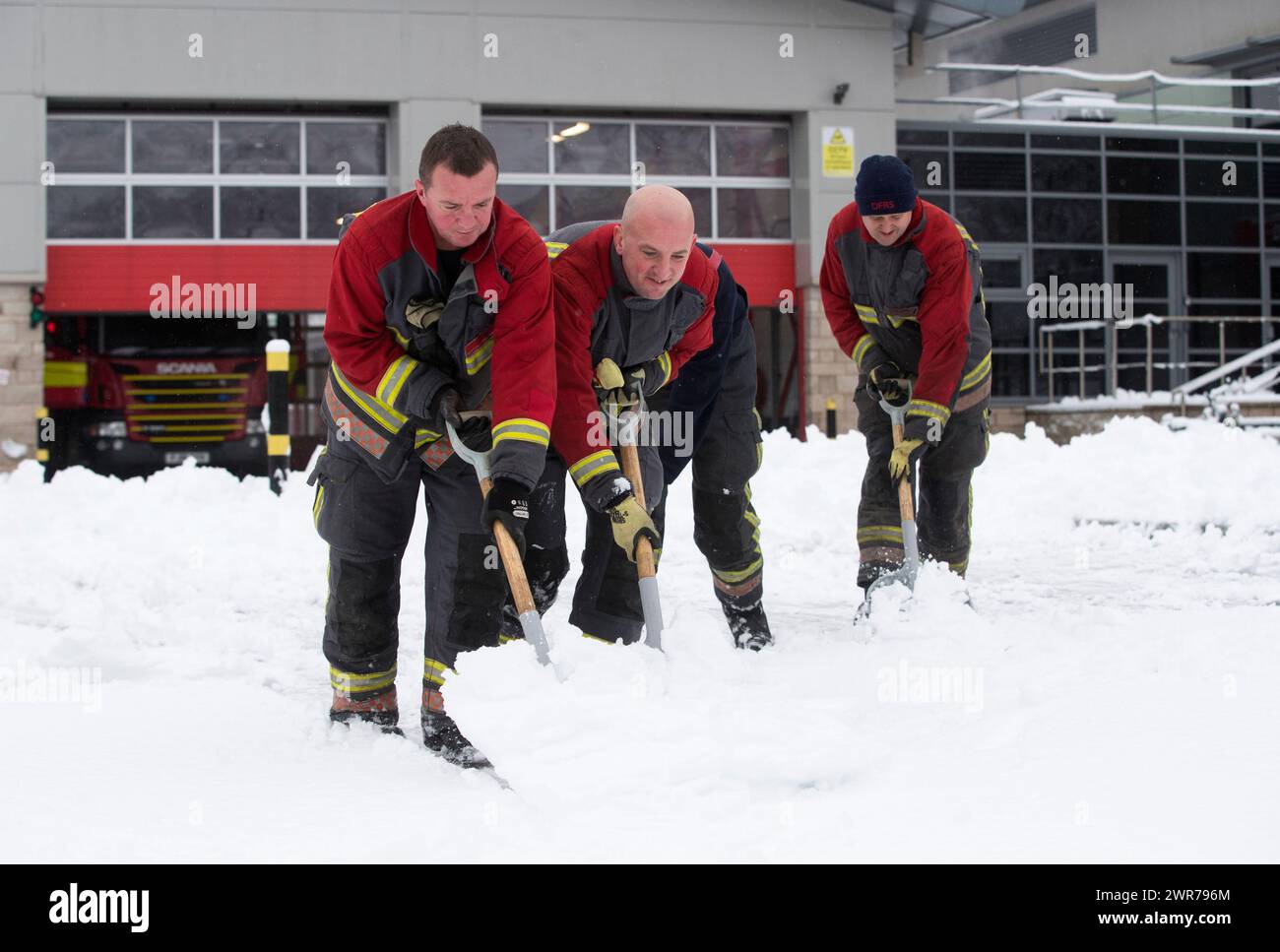 29/12/17  Firefighters clear snow from outside their fire station in Buxton, Derbyshire. Stock Photo