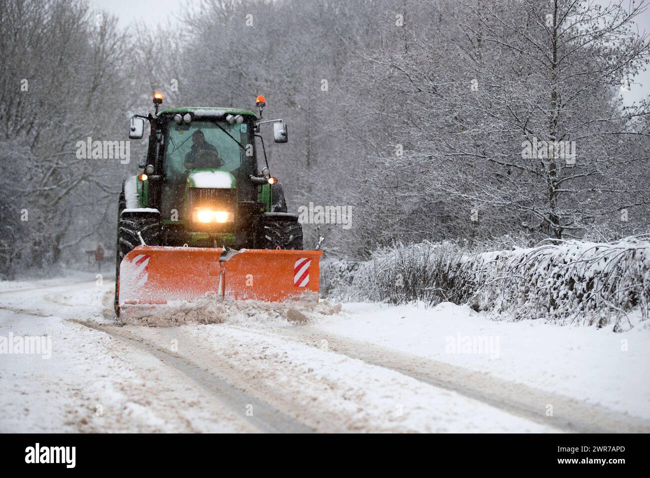 29/12/17  A tractor with a snow plough clears the A515 near Biggin, Derbyshire. Stock Photo