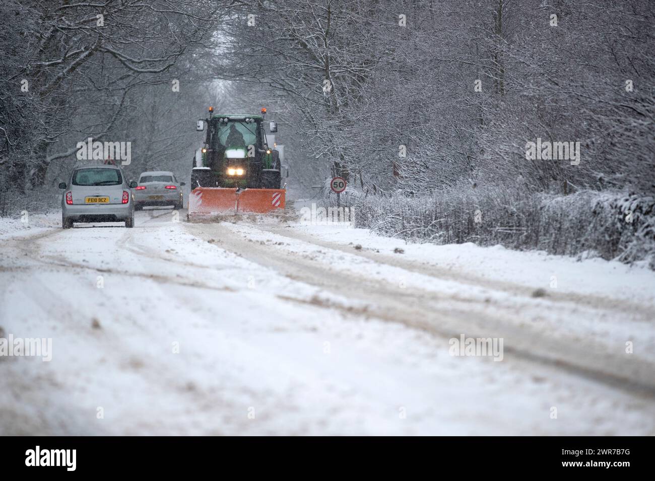 29/12/17  A tractor with a snow plough clears the A515 near Biggin, Derbyshire. Stock Photo
