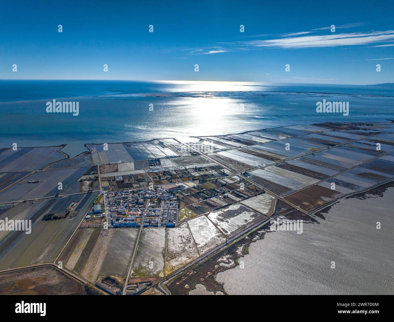 Aerial view of the L'Encanyissada wetland and the village of Poblenou del Delta in backlight on a winter morning (Tarragona, Catalonia, Spain) Stock Photo