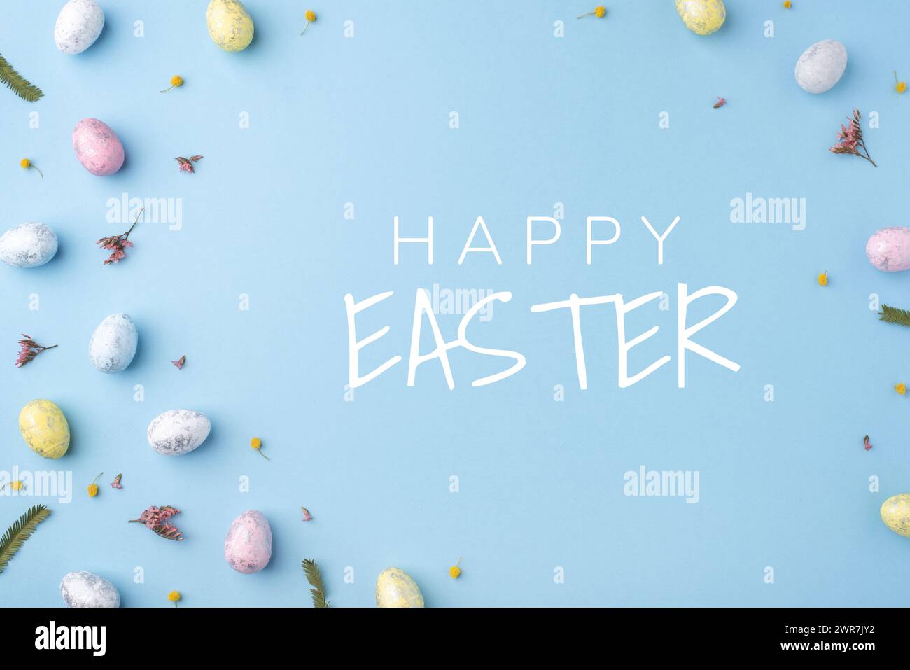 Festive Easter card. Multicoloured Easter eggs on a blue background. Stock Photo