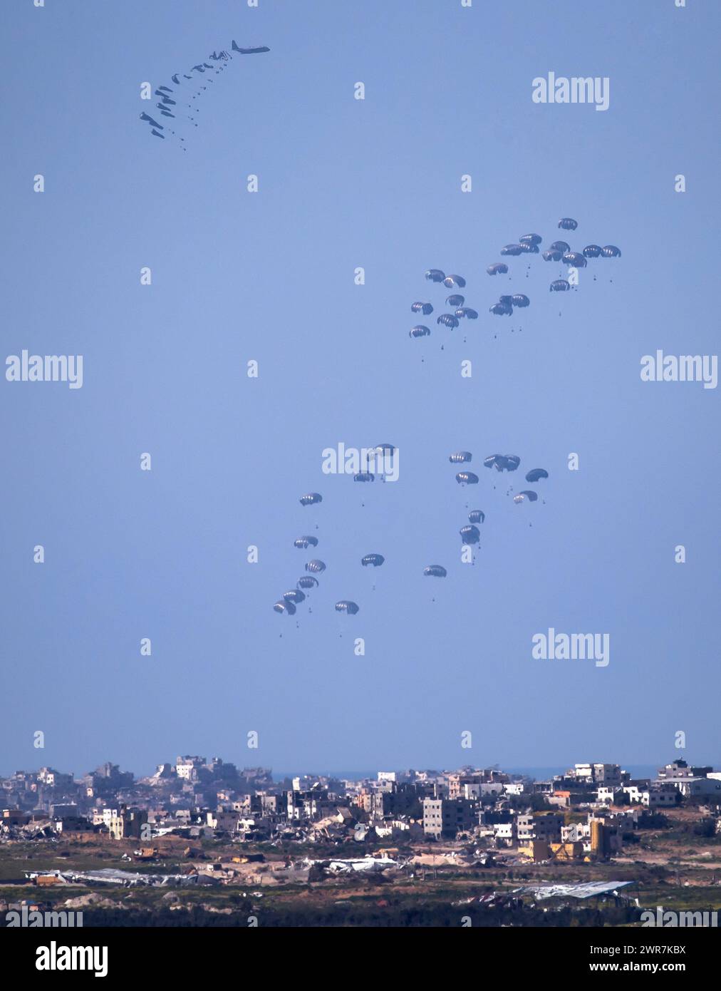 Southern Israel, Israel. 11th Mar, 2024. United States Air Force C-130 drops humanitarian aid by parachute over the central, northern Gaza Strip as seen from inside southern Israel on March 10, 2024. Two previous planes dropped aid immediately before this drop. well.The USA and other countries continue to drop food and other humanitarian aid supplies to Palestinians in dire need in the Gaza Strip on the first day of the month-long Moslem holiday of Ramadan. As reports continue of fighting between Israeli forces and Hamas inside Gaza. Photo by Jim Hollander/UPI Credit: UPI/Alamy Live News Stock Photo