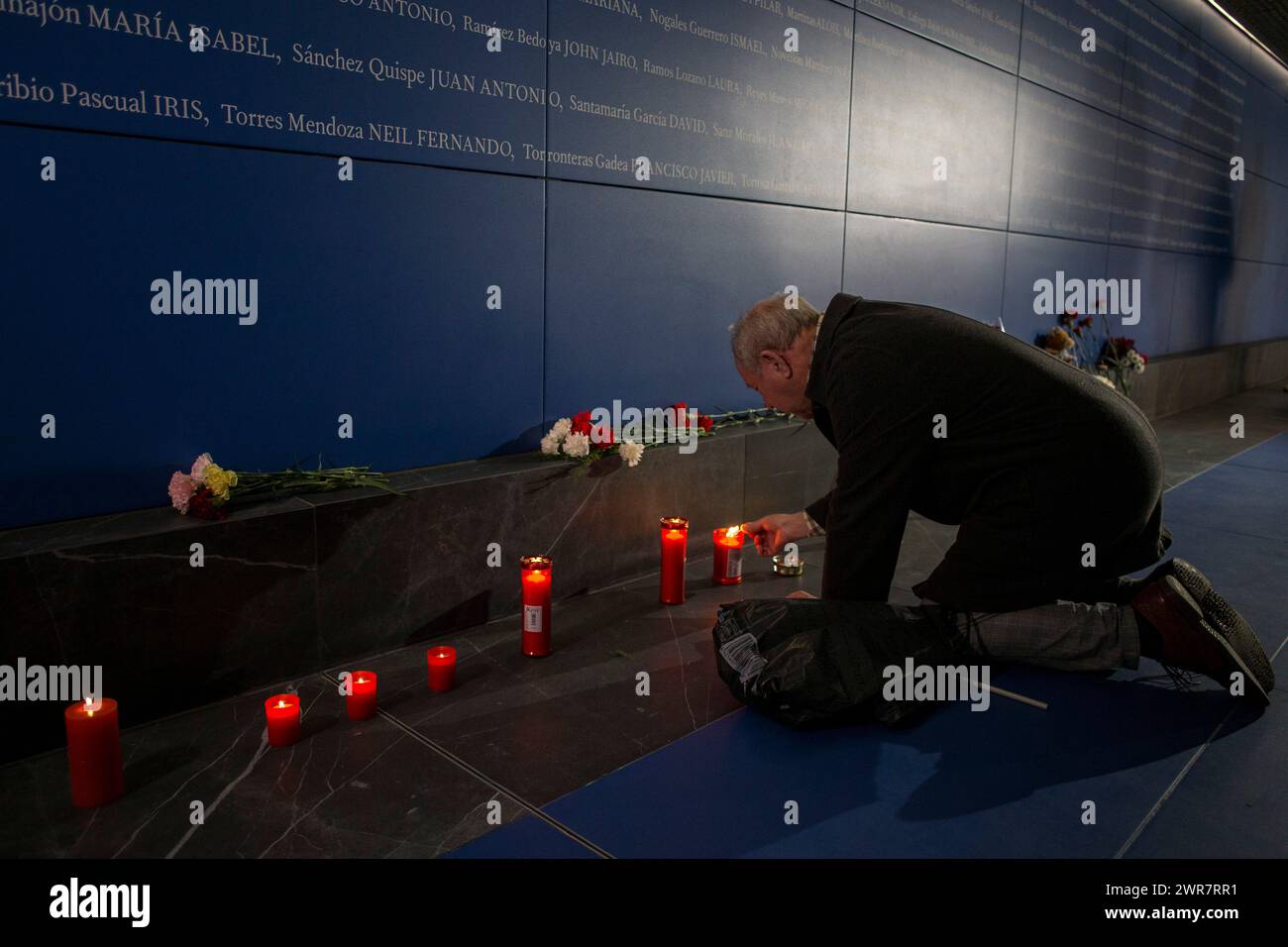 Madrid, Spain. 11th Mar, 2024. A man lights a candle in front of the memorial to the victims of the train bombing inside the Atocha train station in Madrid, during the 20th anniversary of the terrorist attack. On March 11, 2004, several terrorist attacks occurred in Madrid, leaving 193 people dead and around 2,000 injured. Credit: SOPA Images Limited/Alamy Live News Stock Photo