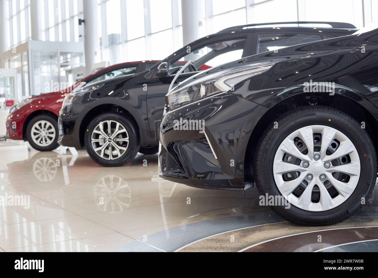 Russia, Izhevsk - February 17, 2022: KIA showroom. New modern cars in KIA showroom. Famous world brand. Prestigious vehicles. Stock Photo