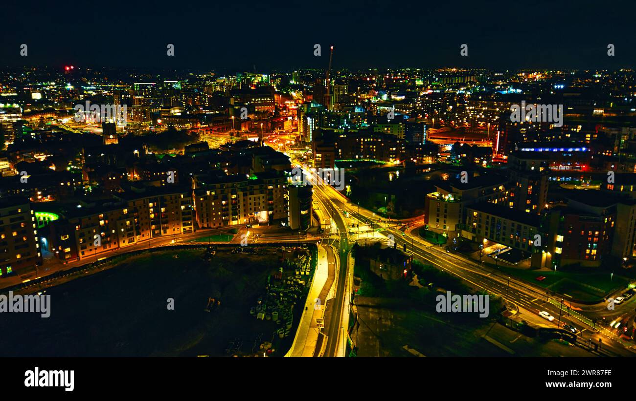 Aerial night view of a cityscape with illuminated streets and buildings ...