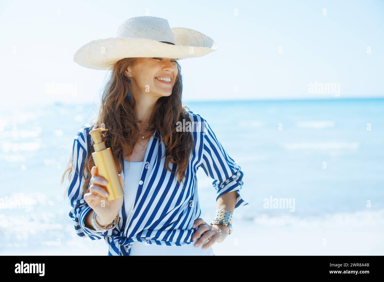 Mature woman beach suncream hi-res stock photography and images - Alamy