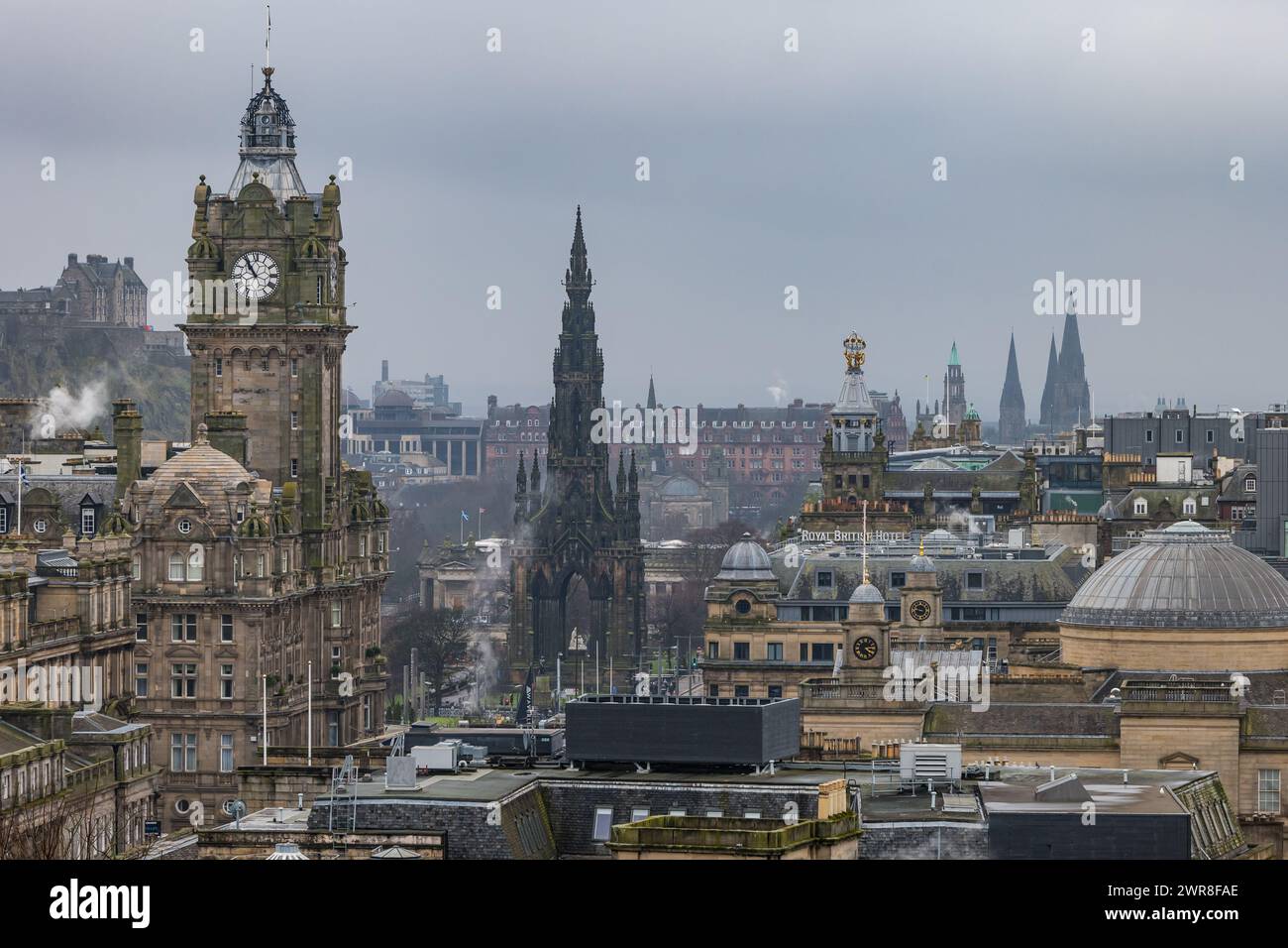 Edinburgh, Scotland, UK, 11th March 2024. UK Weather: dreich overcast wet damp weather in the capital city. A cold damp haze hangs over the city centre with the Balmoral clock visible over the rooftops with church spires in the distance. Credit: Sally Anderson/Alamy Live News Stock Photo