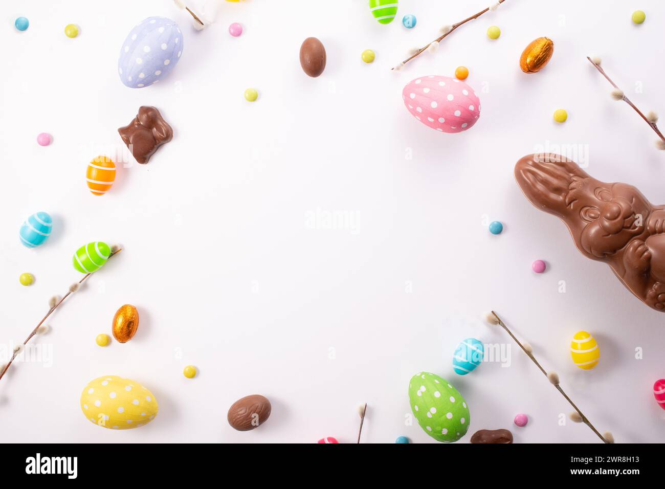 Chocolate eggs, chocolate bunny and sweets on white wooden table.Greetings card, Happy Easters. Flat lay ,top view Stock Photo