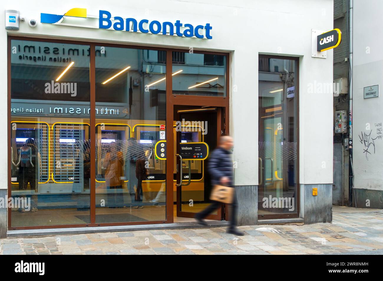 Indoor ATM cash dispenser of bank neutral Bancontact CASH point in shopping street in the city centre of Ghent / Gent, East Flanders, Belgium Stock Photo