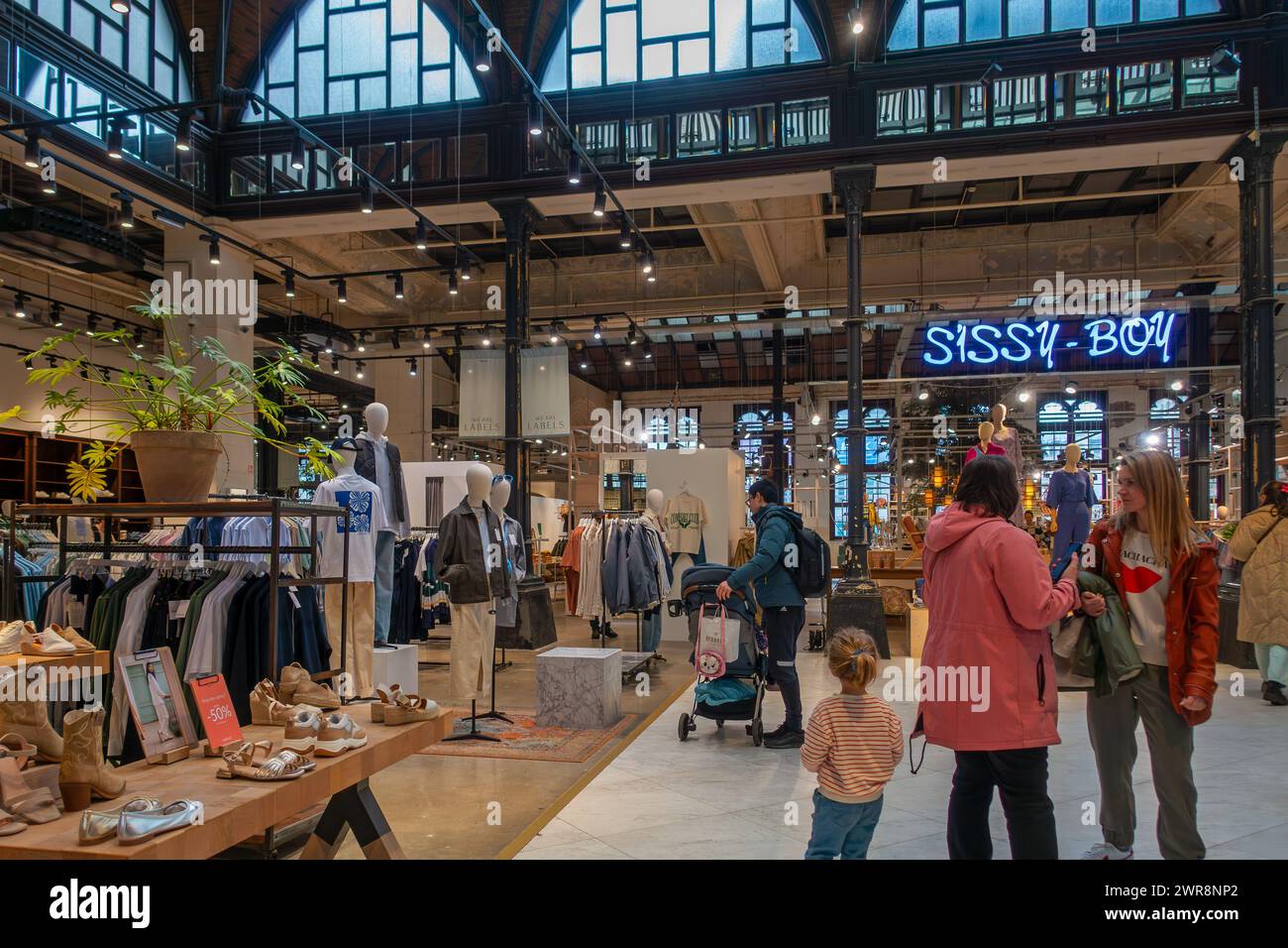 Shopping centre De Post with trendy fashion shops, boutiques and restaurant in the former old post office of the city Ghent, East Flanders, Belgium Stock Photo