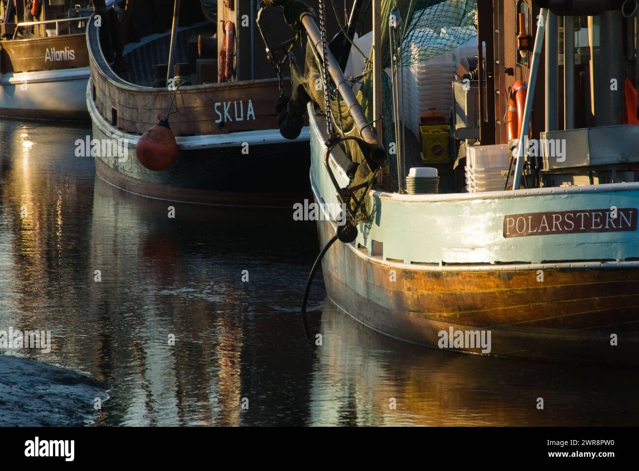 Two big boats moored near a building on water Stock Photo