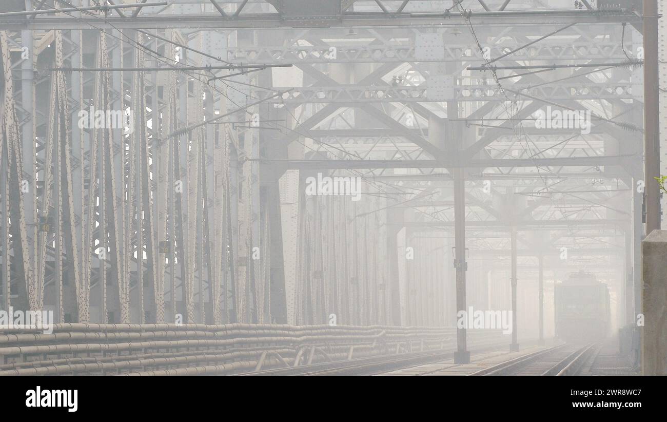 Magical atmosphere of a foggy conditions; a giant railway bridge and a ...