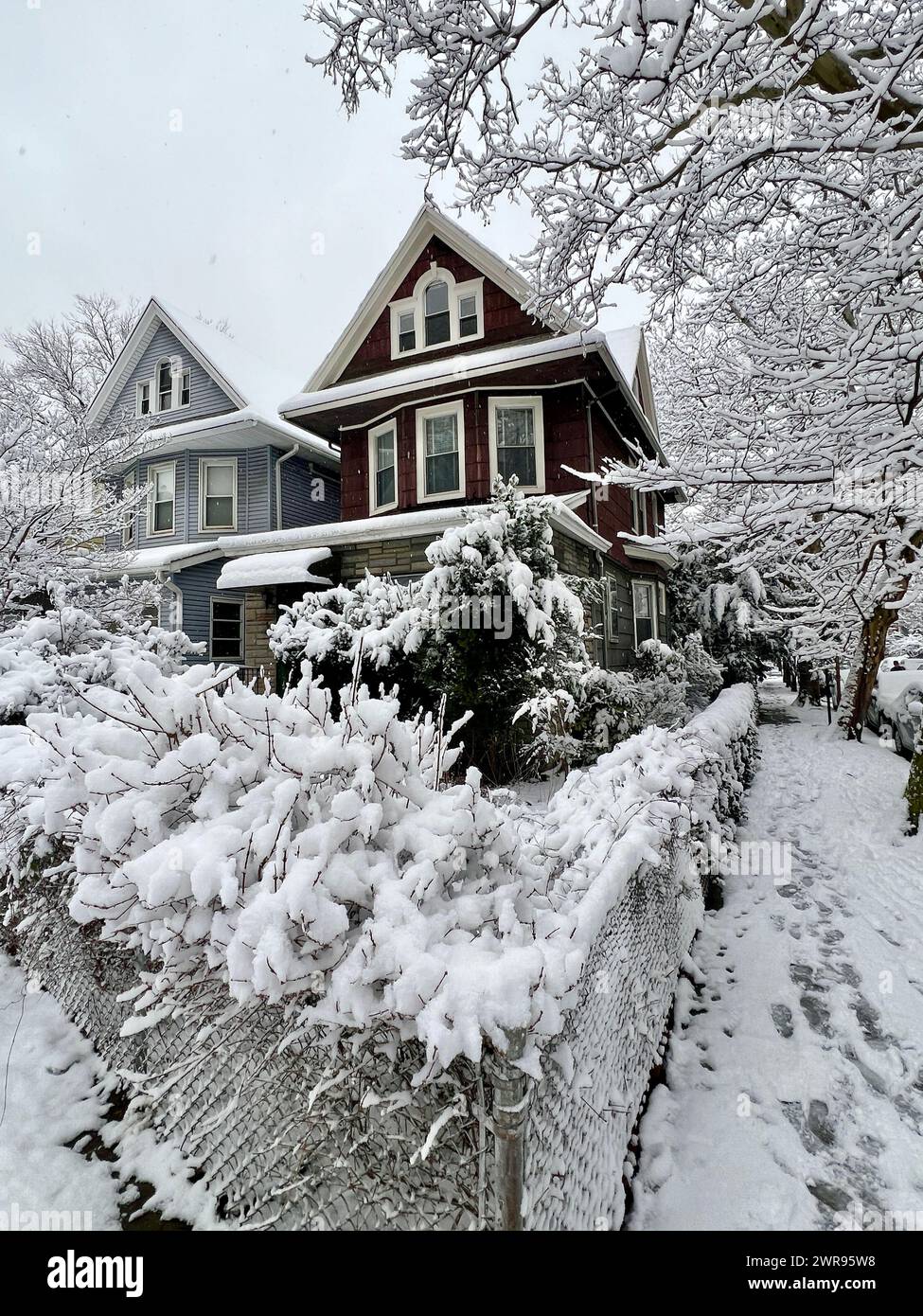 100 year old house on a snowy winter day along E. 7th Street in Brooklyn, New York. Stock Photo